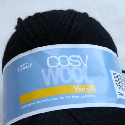 A ball of black Lincraft cosy wool yarn