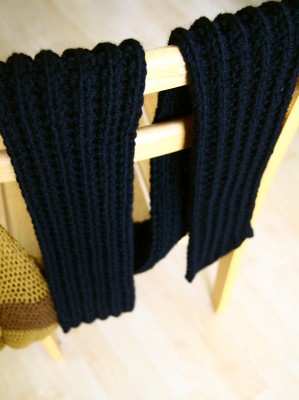 A knitted scarf draped over a chair