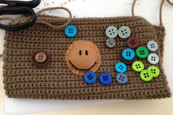 Choosing buttons to use for the monkey pencil case's eyes