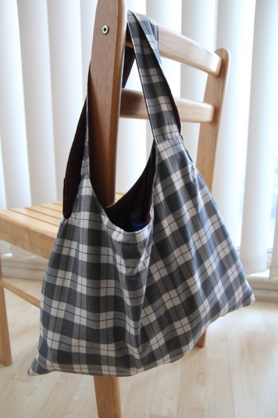 Tag along tote bag hanging from a chair
