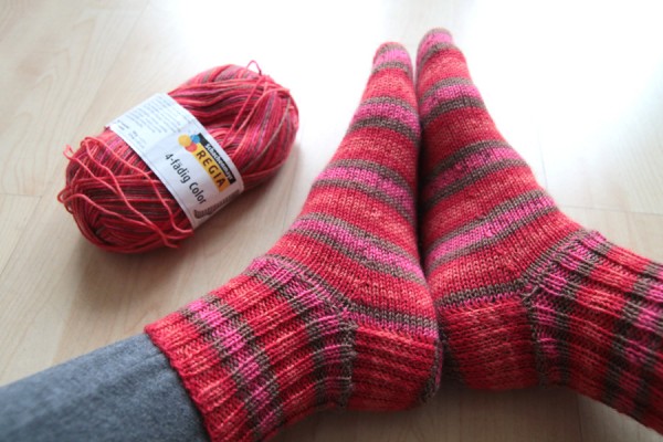 ball of Regia yarn and knitted socks