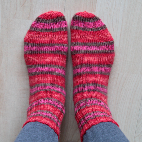 Looking down at feet with striped knitted socks