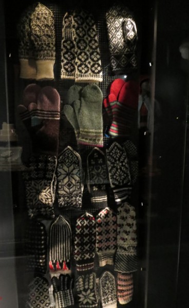 A cabinet containing knitted mittens