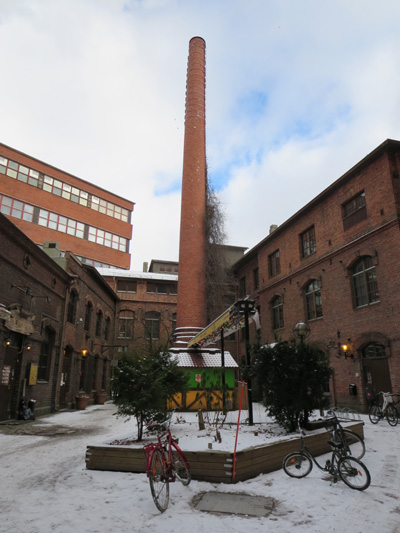 An open area between buildings containing boutique shops