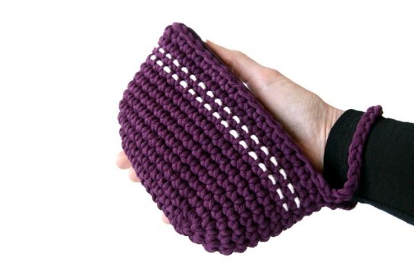 Purple crochet clutch purse held in a hand