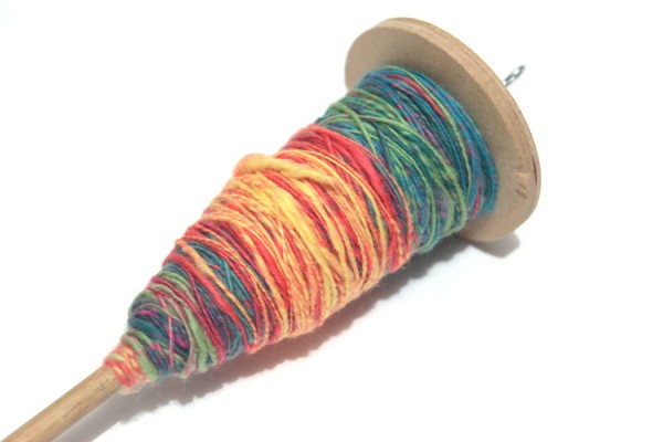 Drop spindle with rainbow coloured yarn